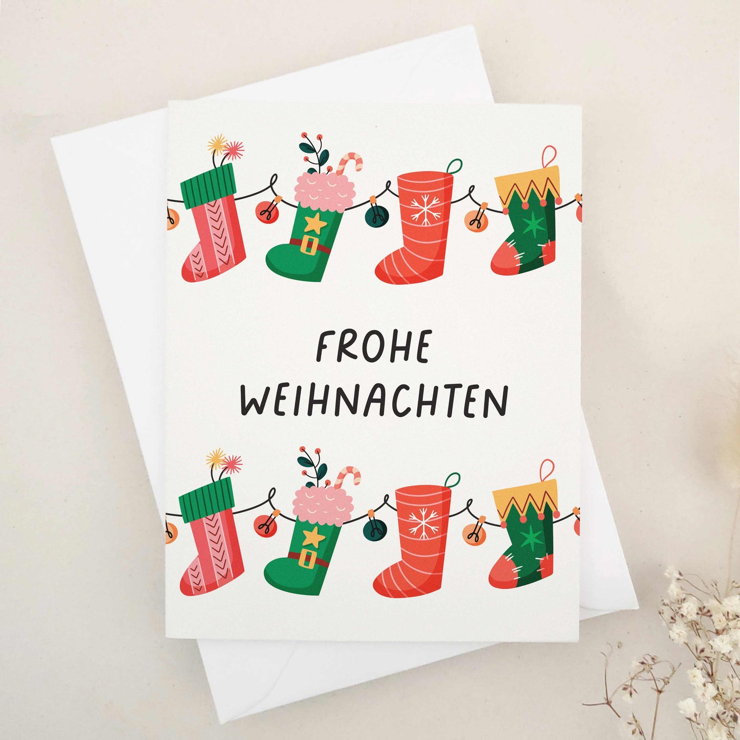 Delightful 'Frohe Weihnachten' card adorned with whimsical Christmas stockings, each festively decorated to capture the cozy and cheerful spirit of the season. The stockings, strung together like a garland, symbolize the connection and joy of the holidays. This card combines traditional German holiday charm with a touch of whimsy, making it perfect for sharing festive wishes.