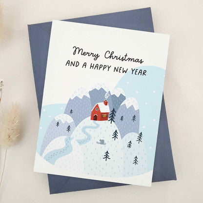 Serene 'Merry Christmas and a Happy New Year' card capturing the tranquil aspect of the festive season, with an illustration of a solitary house in a snow-covered landscape. The picturesque scenery evokes calmness and the simple joys of a quiet winter's day, reflecting a moment of solitude and reflection amidst the bustling holiday festivities, perfect for sharing unique and thoughtful festive greetings.