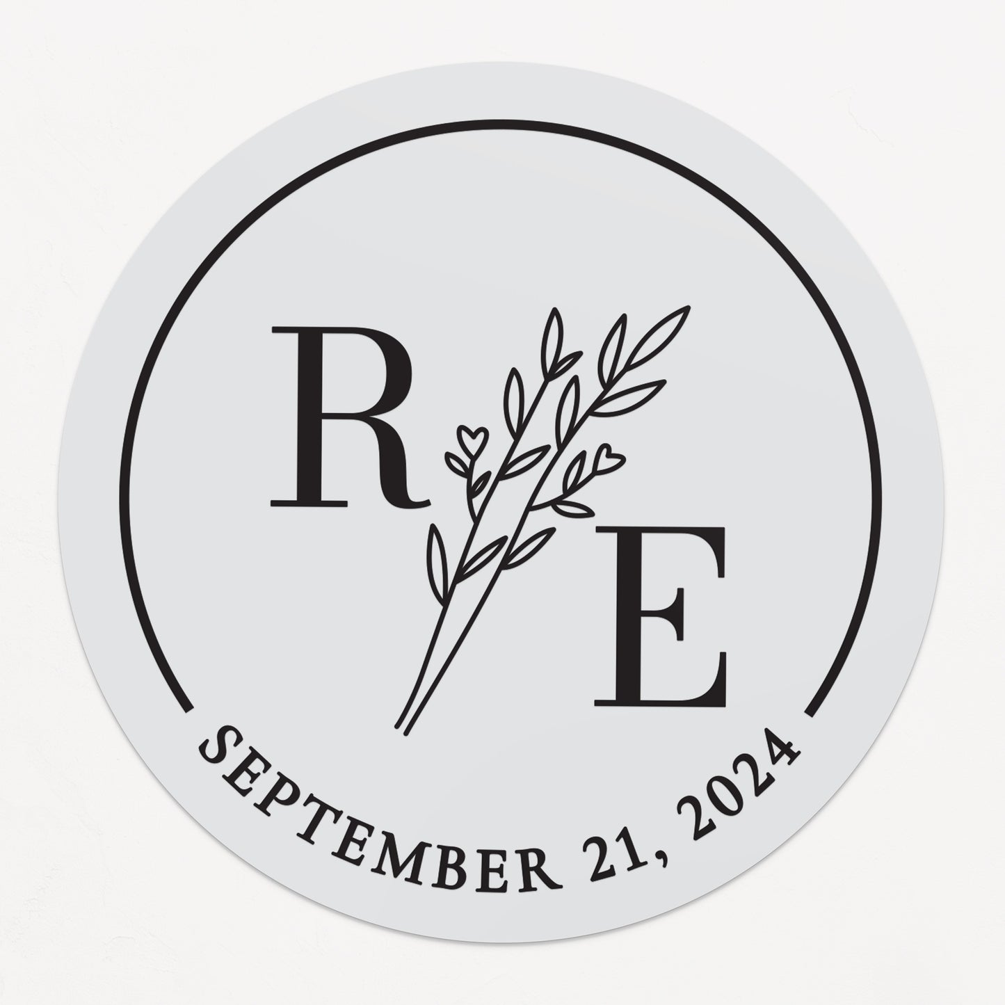 Transparent wedding sticker with golden initials and date, featuring an elegant botanical design