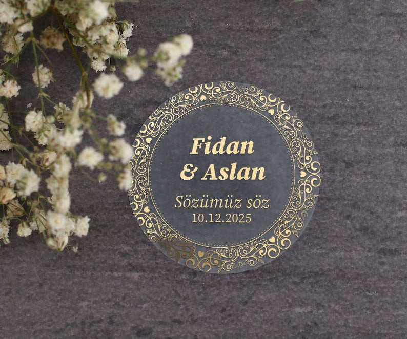 Personalized gold-foil commitment sticker with names, message, and date