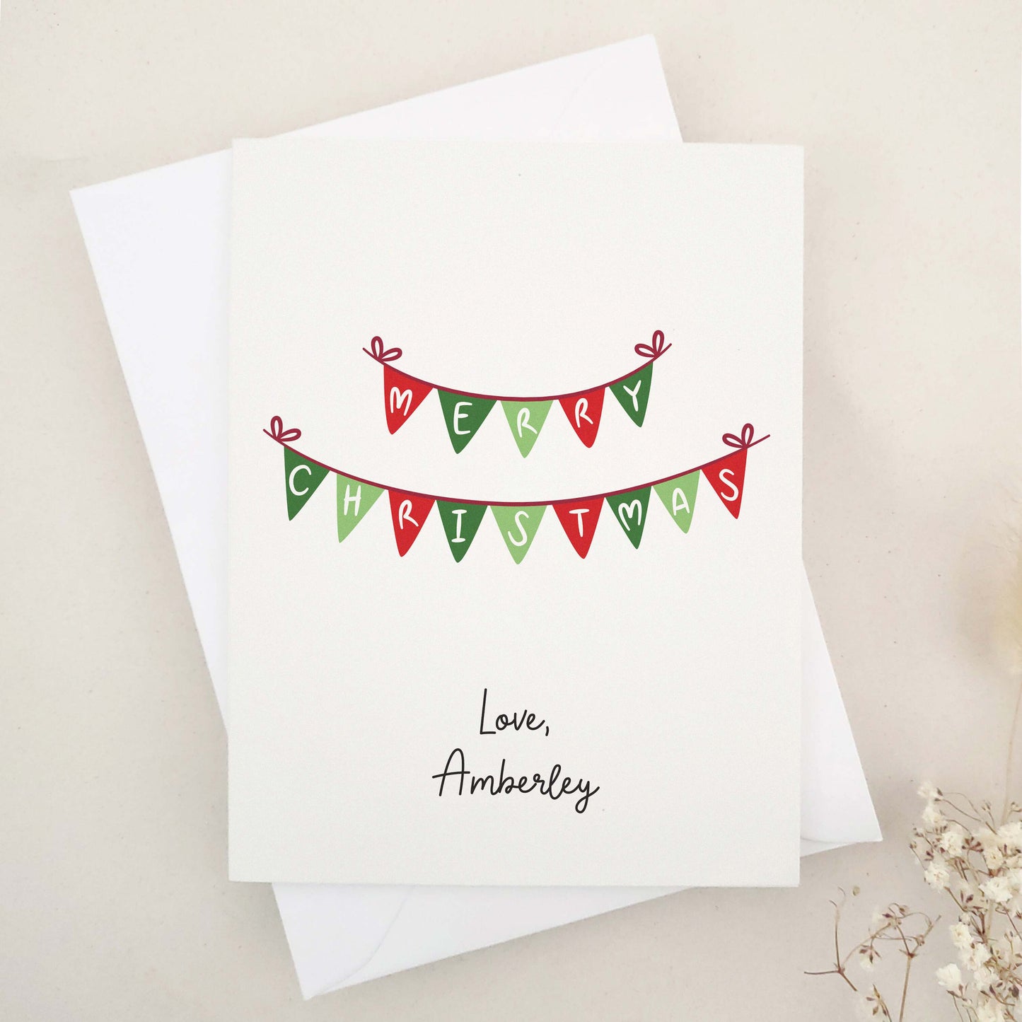 Embrace the festive season with our classic 'Merry Christmas' card: a beautifully simple yet elegant choice featuring traditional Christmas bunting in warm holiday colors, delicately spelling out heartfelt holiday greetings.