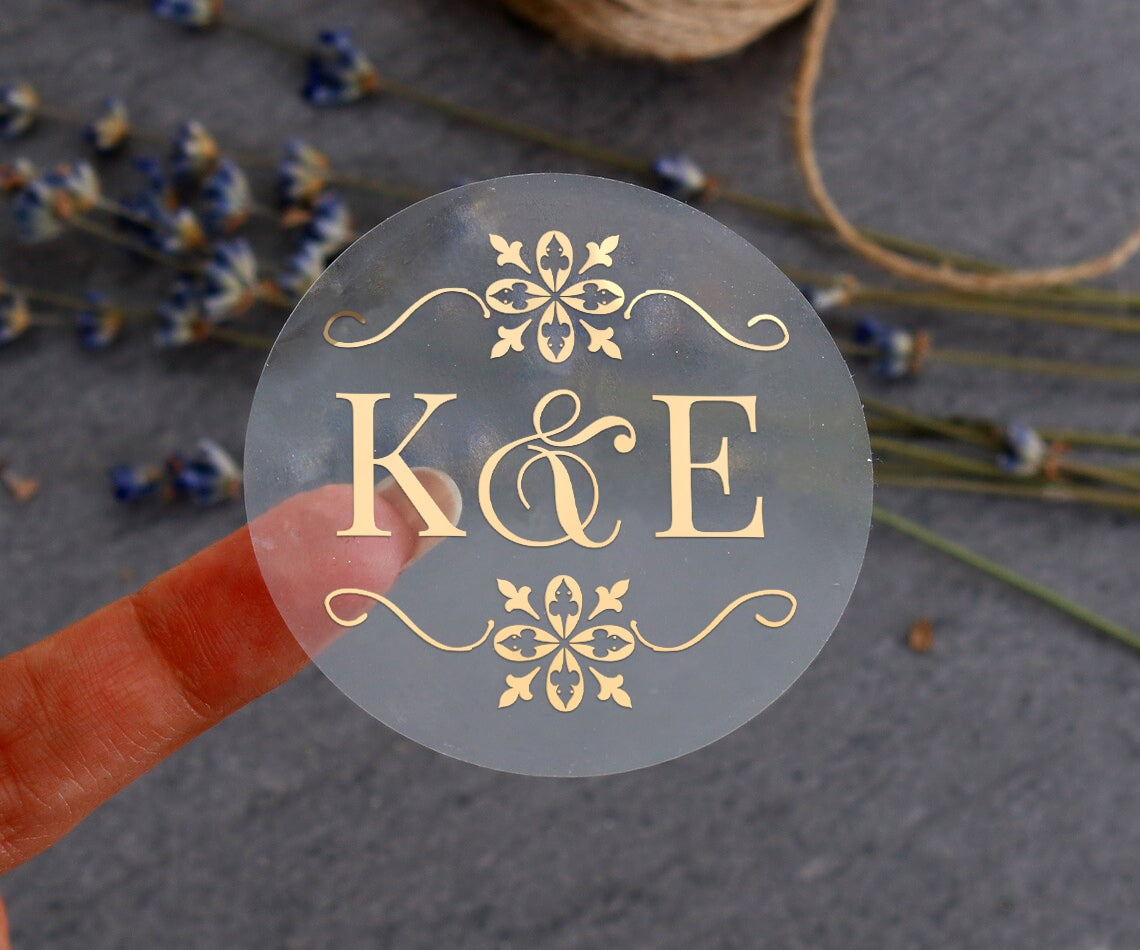 Transparent monogrammed wedding sticker with gold ornaments design and custom initials