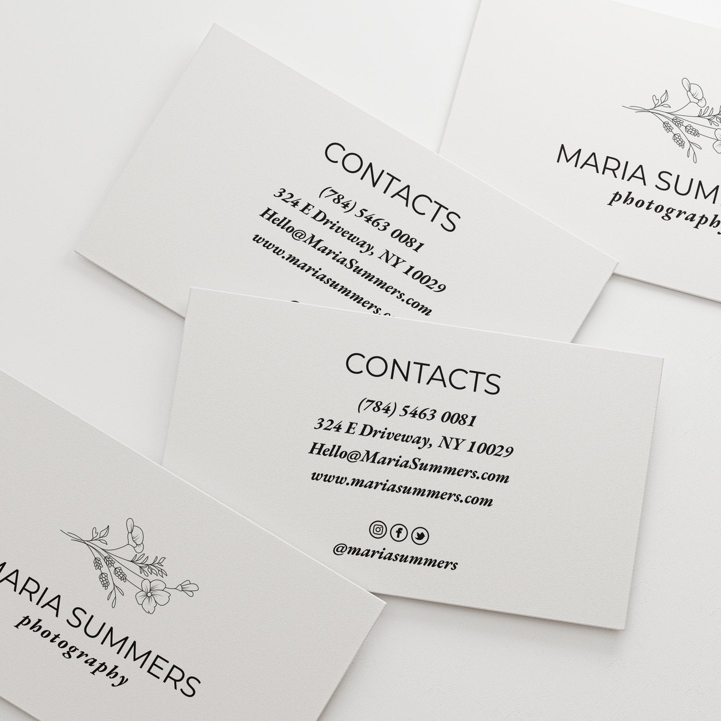 Sleek black and white personalized business cards from XOXOKristen, showcasing a floral illustration and a variety of luxurious text printing options.