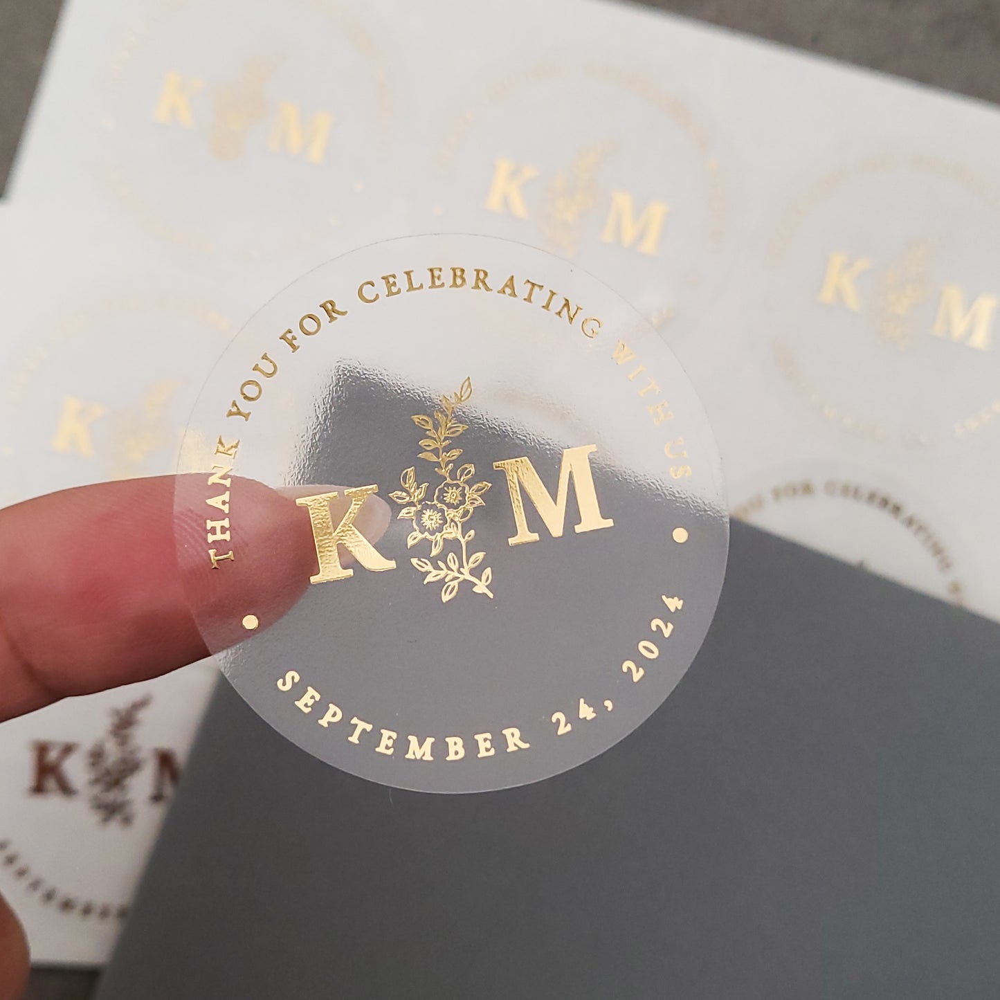 gold foiled monogram wedding favor sticker with thank you for celebrating with us text and floral design, personalized with initials and wedding date - XOXOKristen