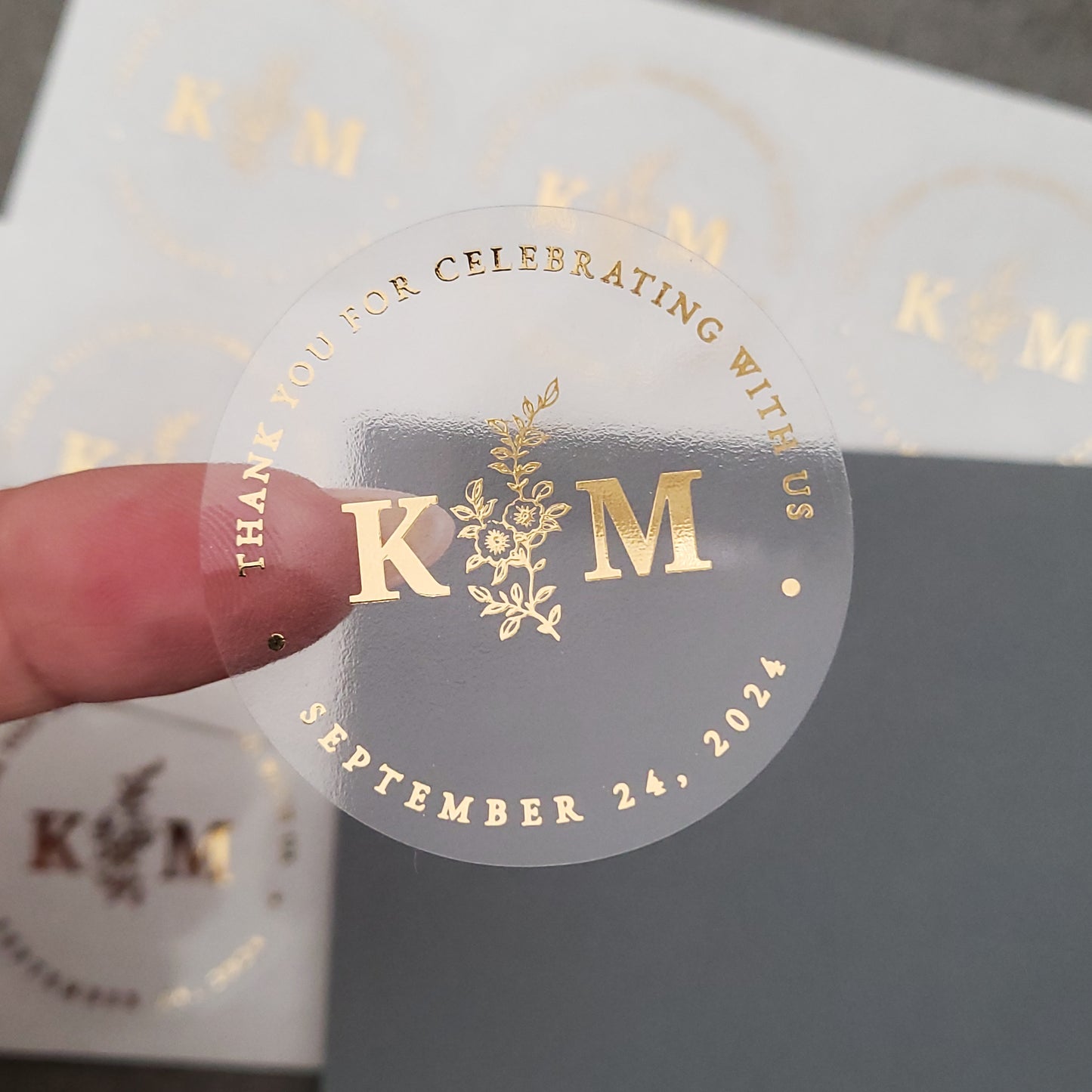 gold foiled monogram wedding favor sticker with thank you for celebrating with us text and floral design, personalized with initials and wedding date - XOXOKristen