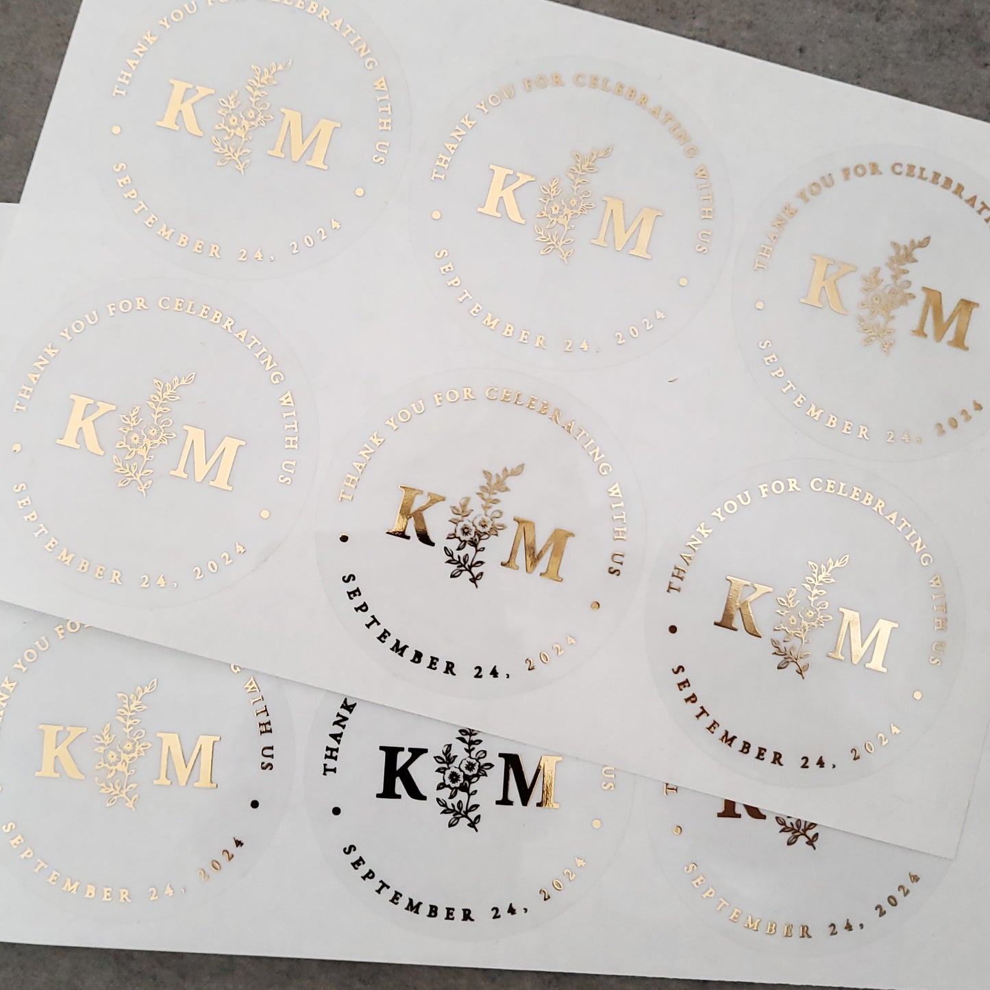 gold foiled monogram wedding favor sticker with thank you for celebrating with us text and floral design, personalized with initials and wedding date - XOXOKristen