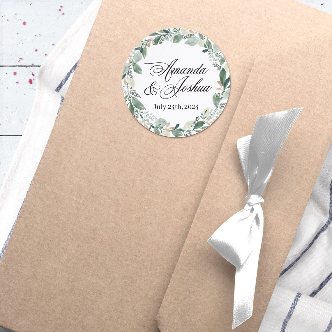 Elegant wedding sticker with genery wreath, personalized with names and wedding date.