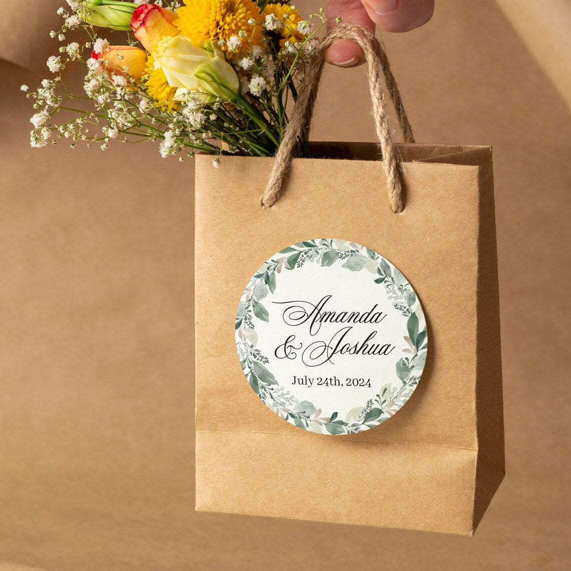 Elegant wedding sticker with genery wreath, personalized with names and wedding date.