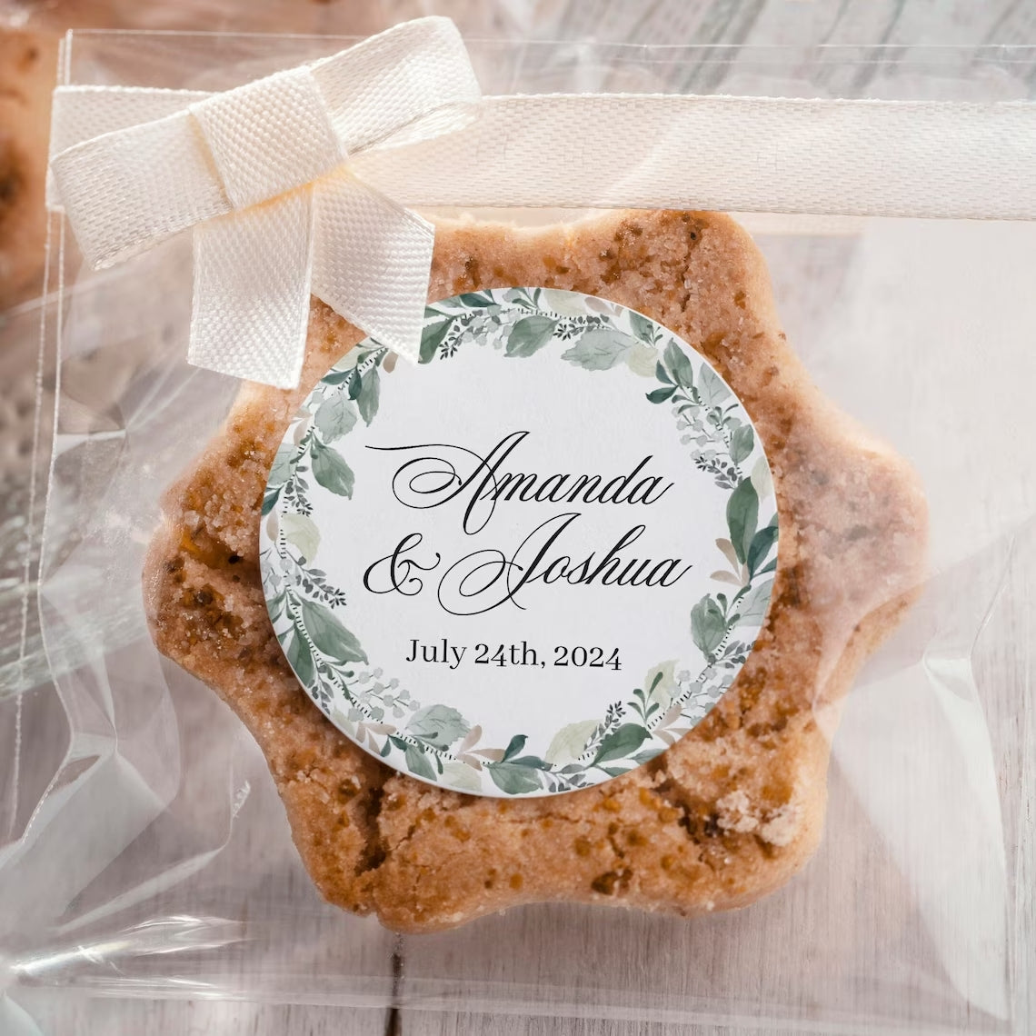 Elegant wedding sticker with genery wreath, personalized with names and wedding date.