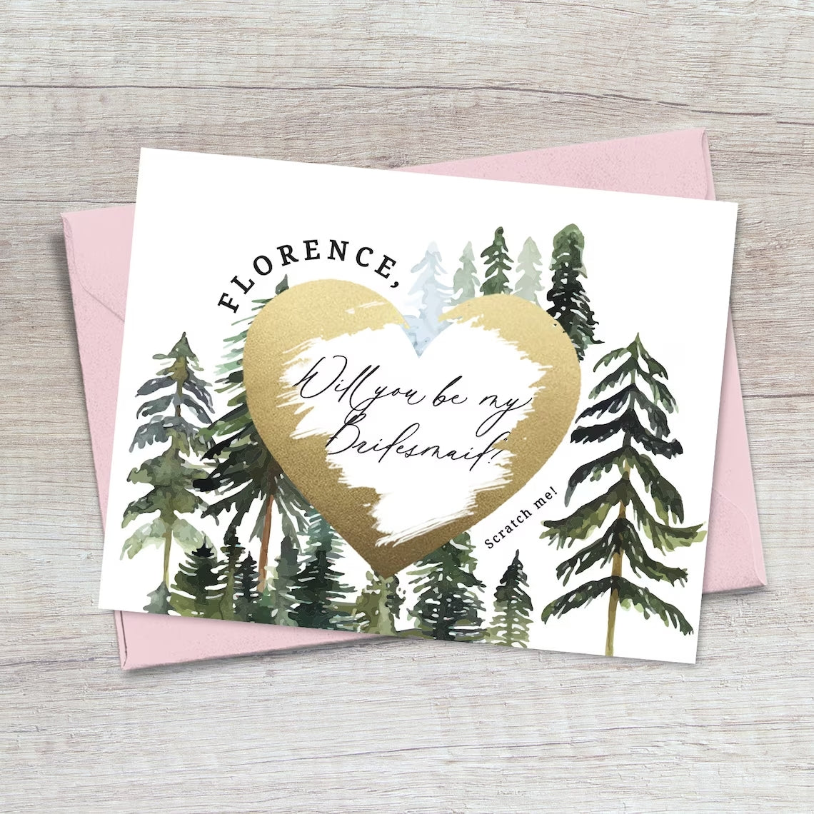 will you be my bridesmaid proposal card with rustic pine trees design and gold foiled cratch off heart in the middle.