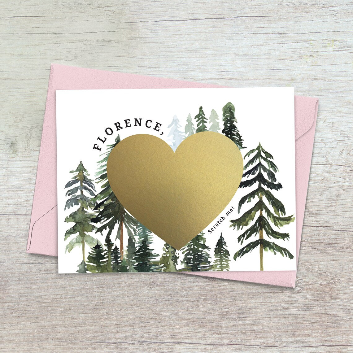 will you be my bridesmaid proposal card with rustic pine trees design and gold foiled cratch off heart in the middle.