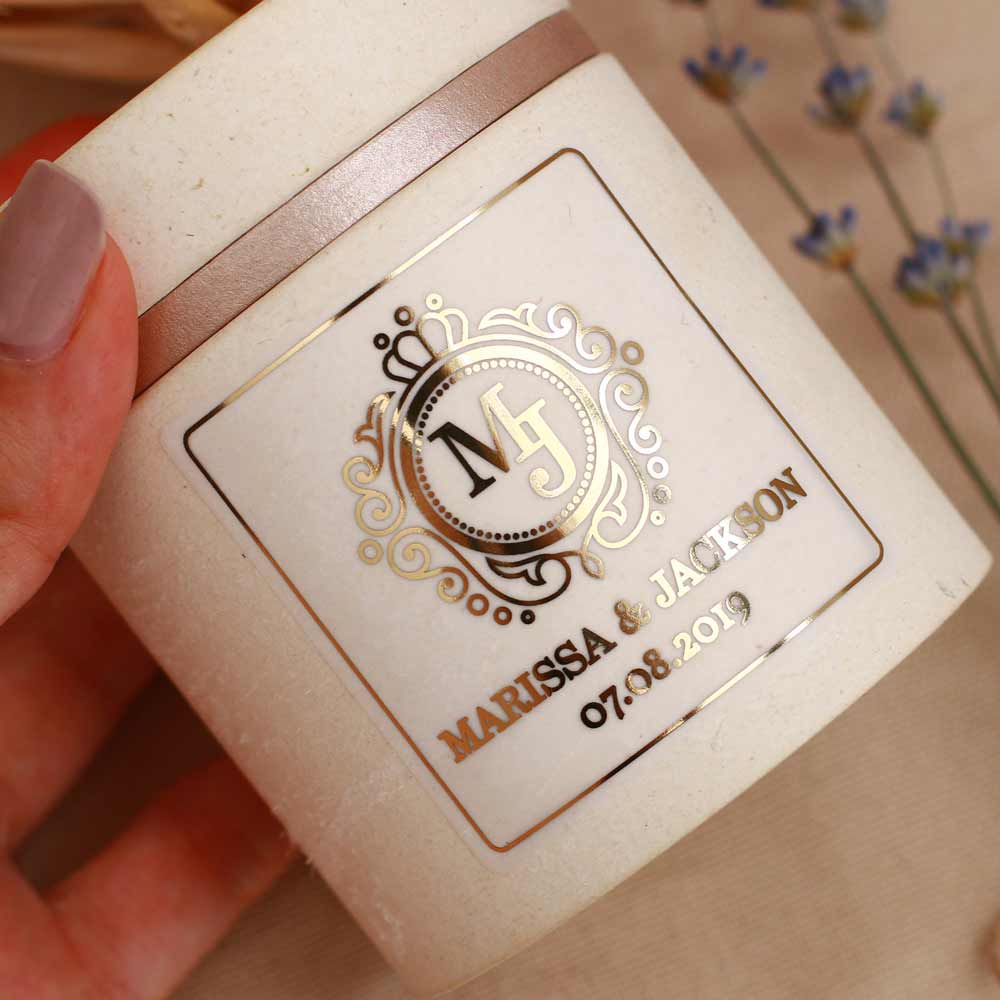 Custom wedding sticker with ornaments and monogram initials. Entirely personalized clear gold foiled label.