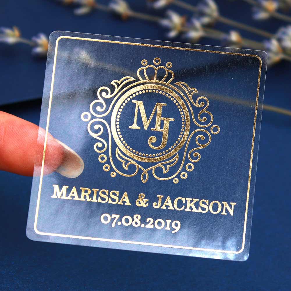 Custom wedding sticker with ornaments and monogram initials. Entirely personalized clear gold foiled label.