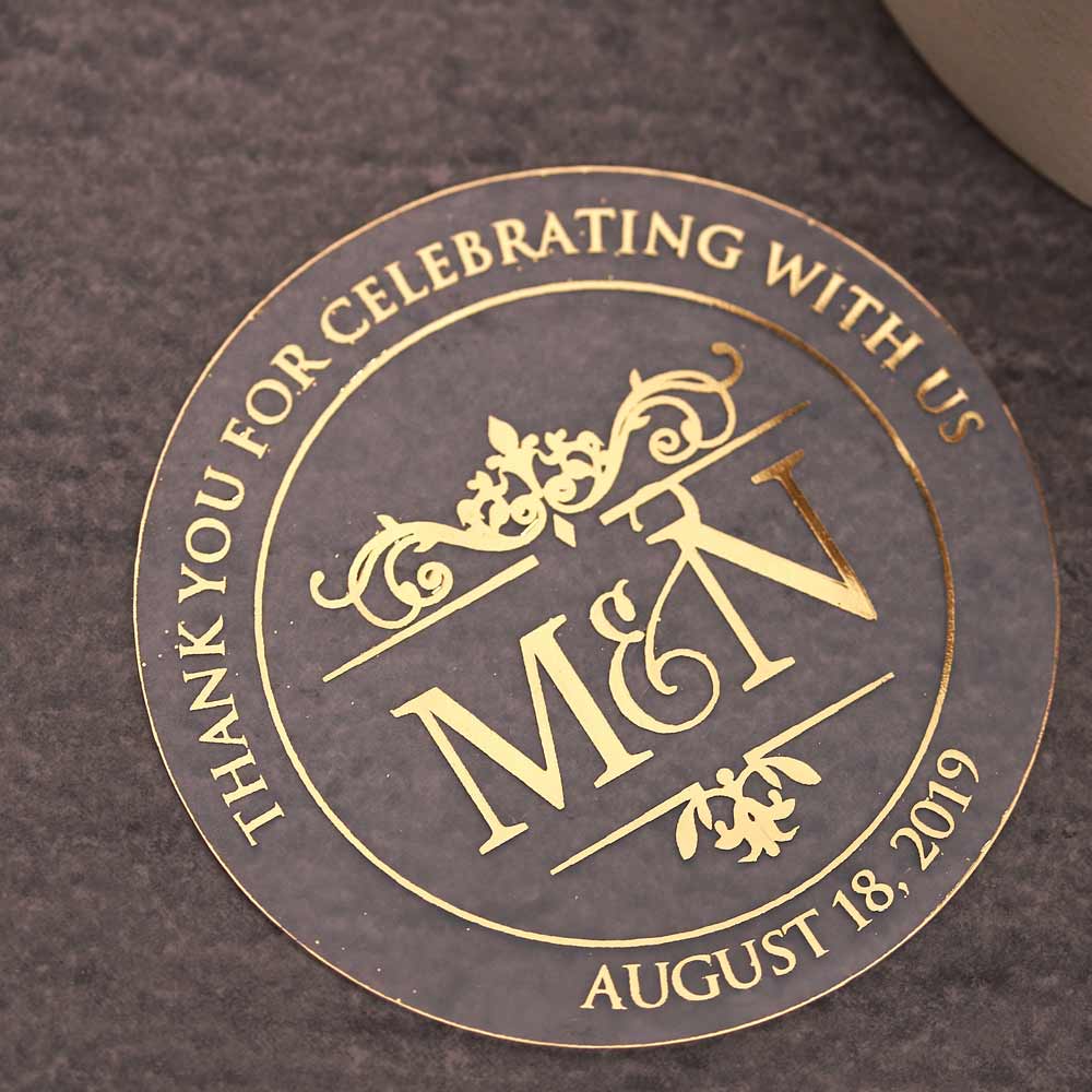 Custom wedding thank you sticker with monogram initials and gold foiled lettering. Entirely personalized clear labels.