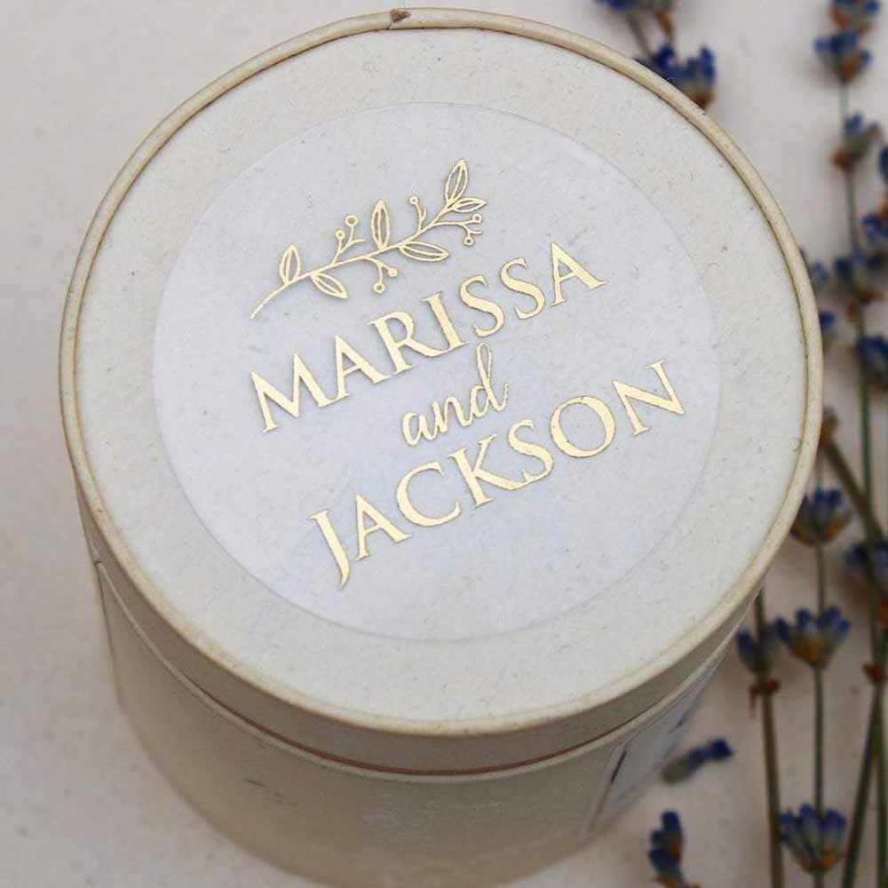 Custom wedding sticker with real gold foiled lettering and leaf ornament. Entirely personalized clear labels.