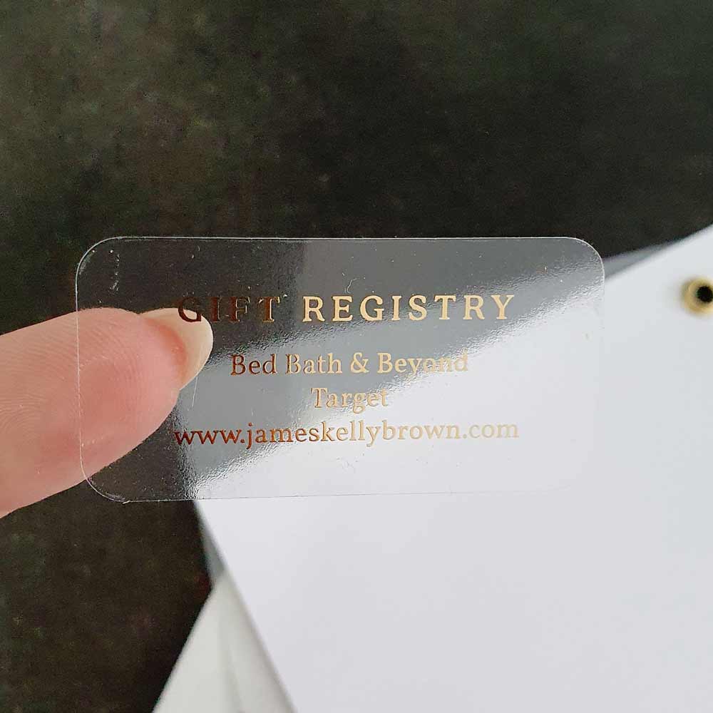 Custom wedding girt registry sticker with real gold foiled lettering. Entirely personalized clear label.