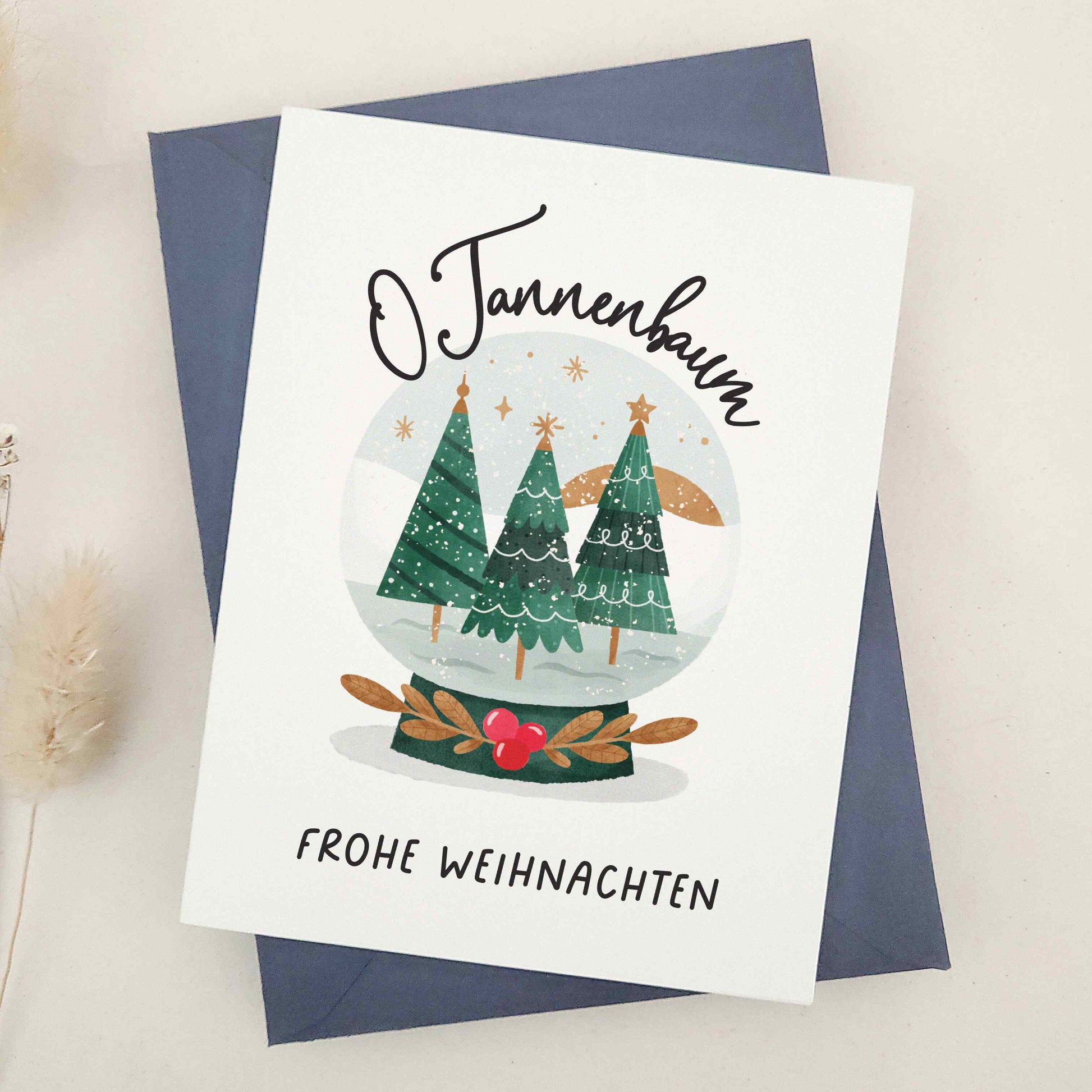 Enchanting 'O Tannenbaum, Frohe Weihnachten' card, paying homage to the classic German Christmas carol. Features a serene snow globe scene with evergreen trees, capturing the essence of 'O Tannenbaum'. The imagery creates a magical, peaceful winter evening atmosphere, reflecting the enduring charm and warmth of the holiday season.