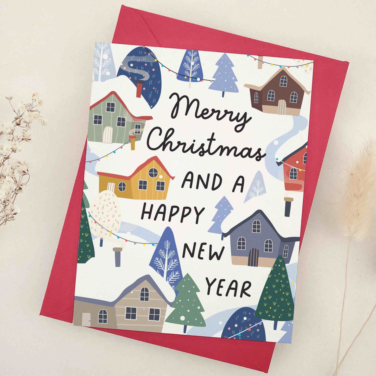 Elegant 'Merry Christmas and a Happy New Year' card depicting a cozy winter scene with snow-covered houses and festive decorations. The design vividly captures the serene and joyous atmosphere of the holiday season, highlighting the warmth and charm of winter celebrations, ideal for sharing heartfelt season's greetings and best wishes.