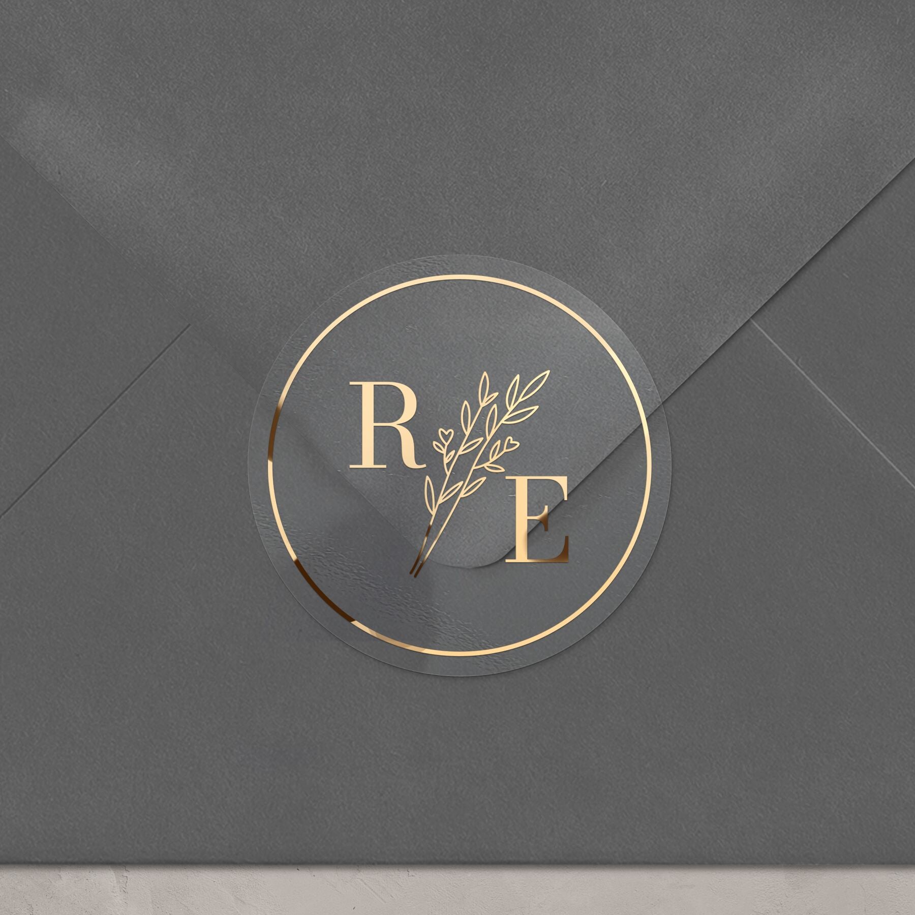 Clear custom wedding sticker with golden initials and botanical illustration.