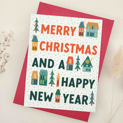 Merry Christmas and a Happy New Year card by XOXOKristen, featuring a picturesque winter village scene with quaint houses and evergreen trees, adorned with vivid colors and whimsical imagery, embodying festive cheer and hopeful spirit.