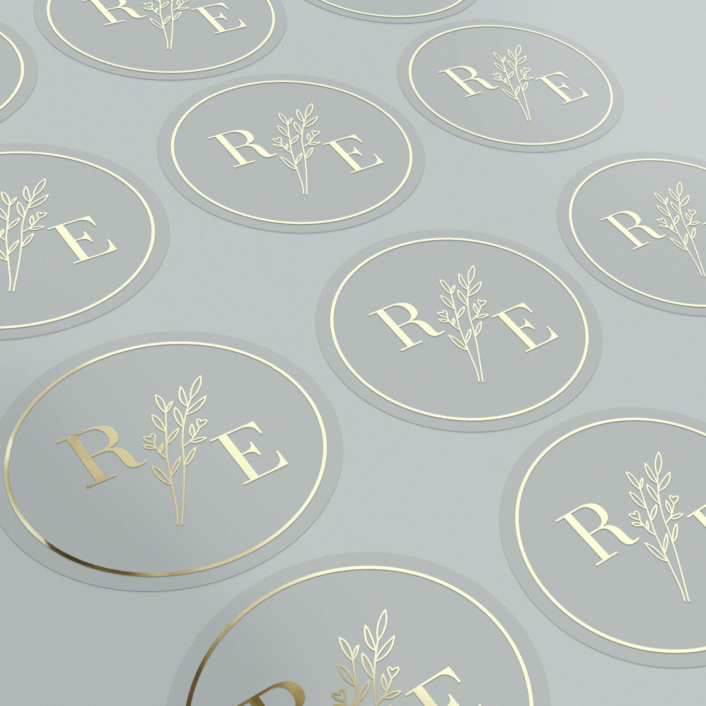 Clear custom wedding sticker with golden initials and botanical illustration.