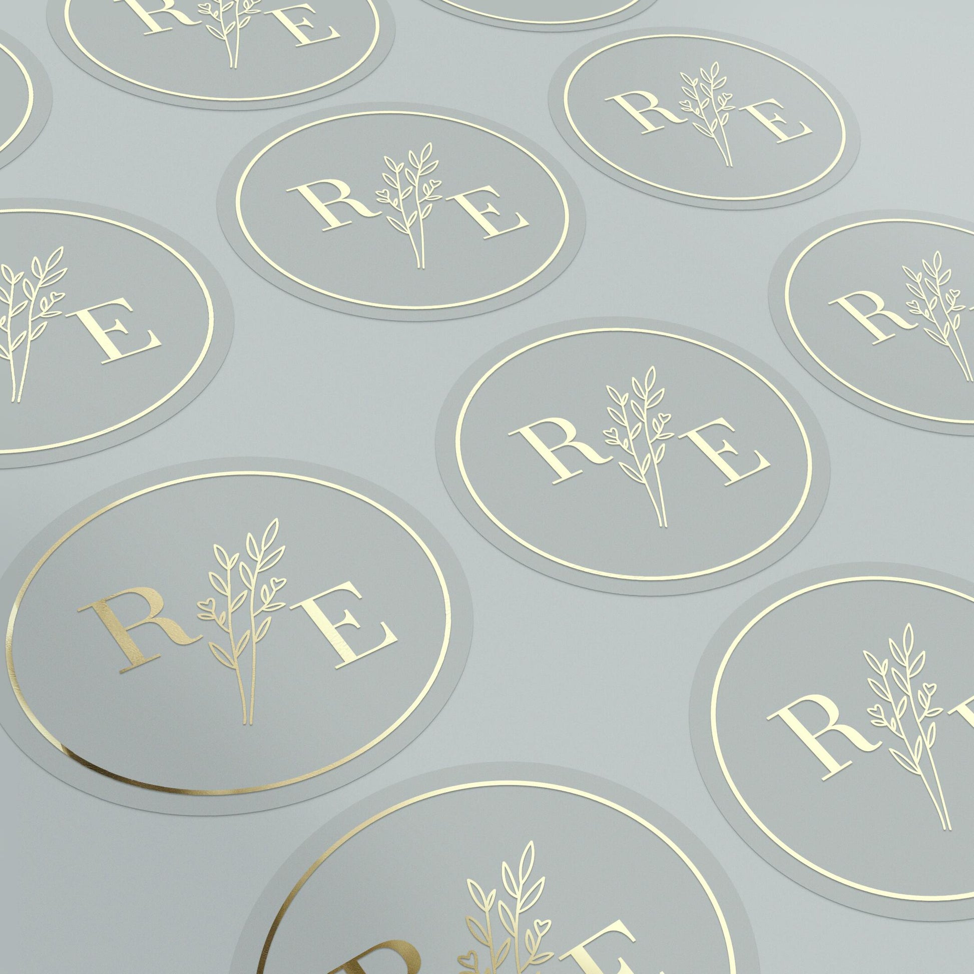 Clear custom wedding sticker with golden initials and botanical illustration.