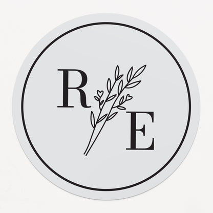 Clear custom wedding sticker with golden initials and botanical illustration.