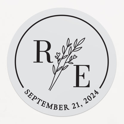 Transparent wedding sticker with golden initials and date, featuring an elegant botanical design