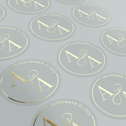 Transparent wedding sticker with gold initials and date, decorated with elegant infinity sign.