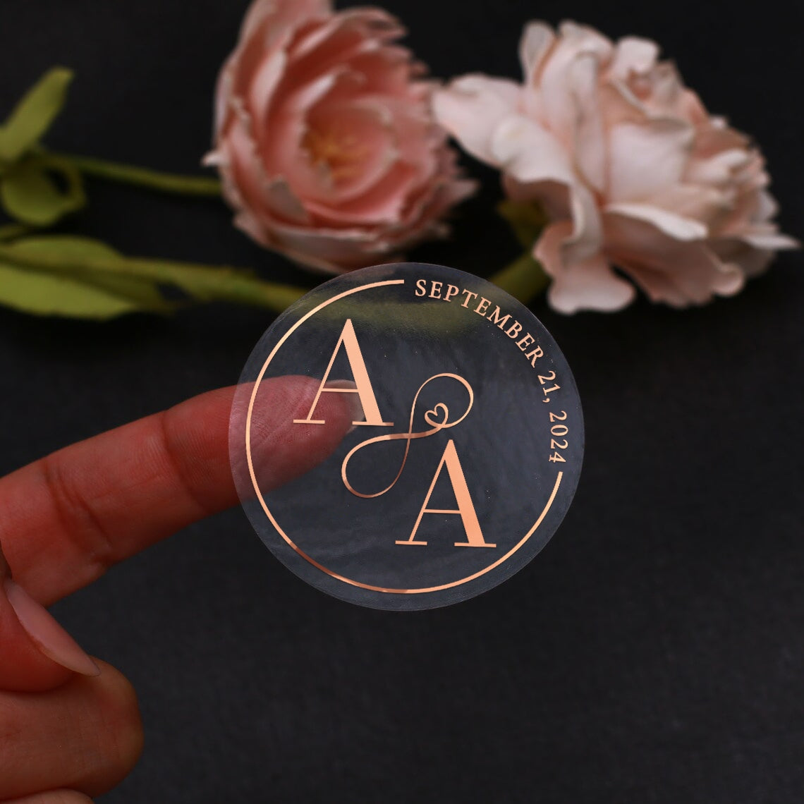 Transparent wedding sticker with gold initials and date, decorated with elegant infinity sign.