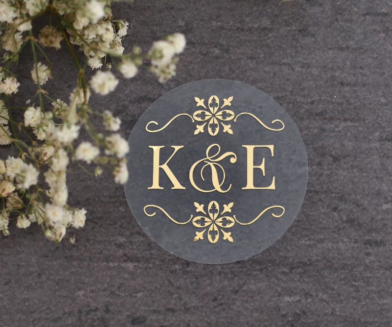 Transparent monogrammed wedding sticker with gold ornaments design and custom initials