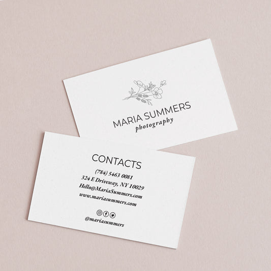 Sleek black and white personalized business cards from XOXOKristen, showcasing a floral illustration and a variety of luxurious text printing options.