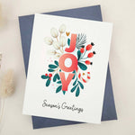 Standing card with “JOY” floral design and “Season’s Greetings” text, displayed with a coordinating envelope — XOXOKristen.