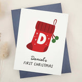 First Christmas card featuring stocking and holly design, styled with navy envelope – XOXOKristen