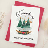 Standing card with “O Tannenbaum” and “Frohe Weihnachten” text, decorated with a snow globe of Christmas trees, styled with red envelope — XOXOKristen.