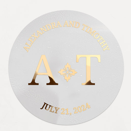 Clear wedding sticker with full names, initials, floral accent, and date