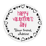 XOXOKristen round Valentine’s Day sticker close-up, white label with playful black heart outline and pink lettering – XOXOKristen