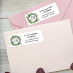 XOXOKristen custom greenery wreath address labels on pastel pink envelopes, featuring botanical leaves and monogram detail - XOXOKristen
