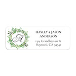XOXOKristen close-up of return address label with circular leafy wreath, black monogram letter, and modern serif typography - XOXOKristen