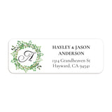 XOXOKristen close-up of return address label with circular leafy wreath, black monogram letter, and modern serif typography - XOXOKristen