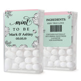 Custom Mint To Be label in pastel green and blush pink with floral illustration, displayed on front and back of Tic Tac mint container.