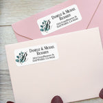 Close-up of personalized return address label with leafy eucalyptus watercolor accent and bold serif font for names and address - XOXOKristen