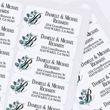 Custom address label stickers displayed on pink and burgundy envelopes, featuring monogram with green eucalyptus design and serif typography - XOXOKristen