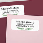 Custom return address labels on pink and burgundy envelopes, decorated with watercolor pine branch motif and classic serif text - XOXOKristen