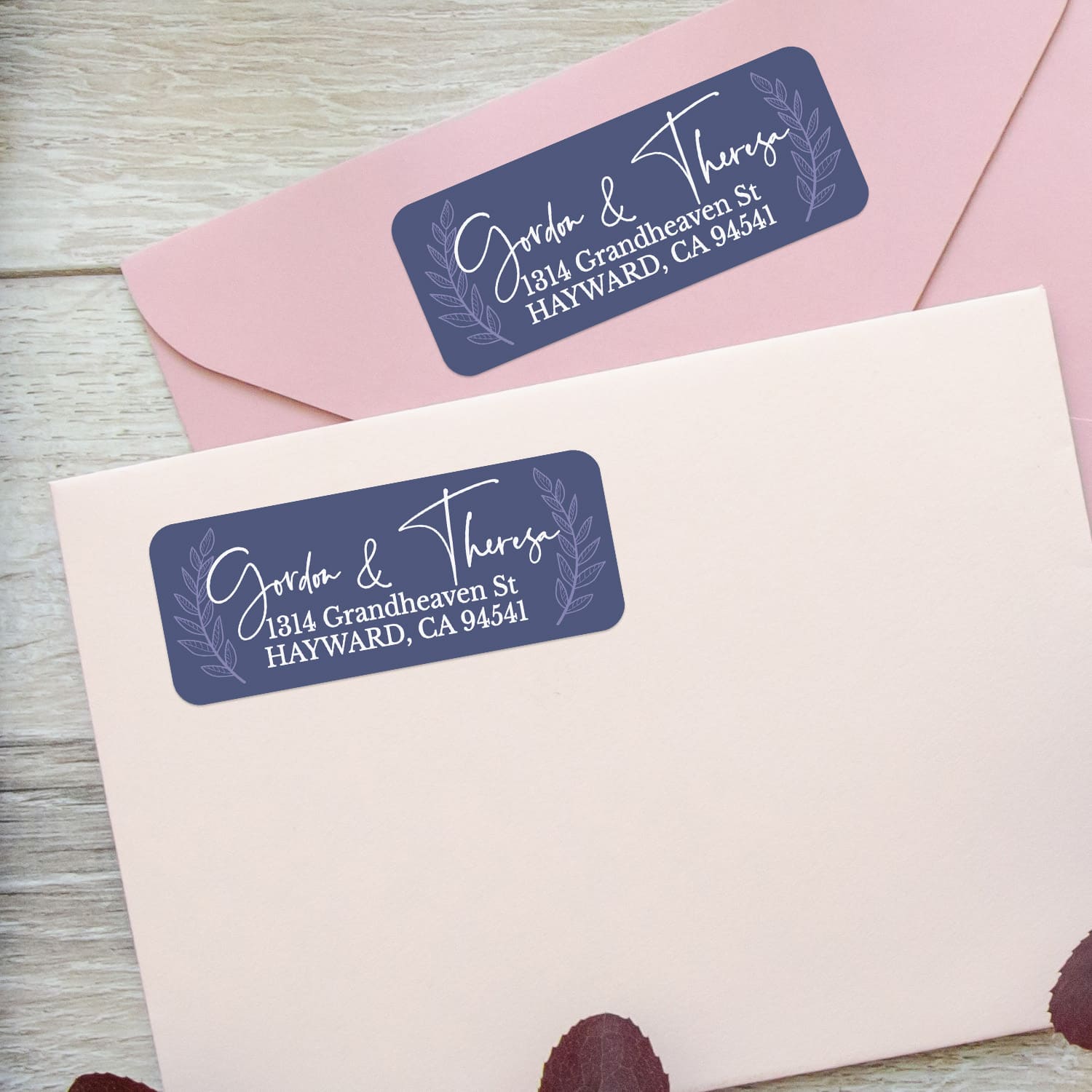 Custom address label stickers on pink and burgundy envelopes, featuring navy background with laurel motif and elegant handwritten script - XOXOKristen