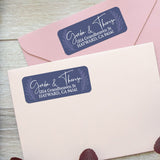 Custom address label stickers on pink and burgundy envelopes, featuring navy background with laurel motif and elegant handwritten script - XOXOKristen