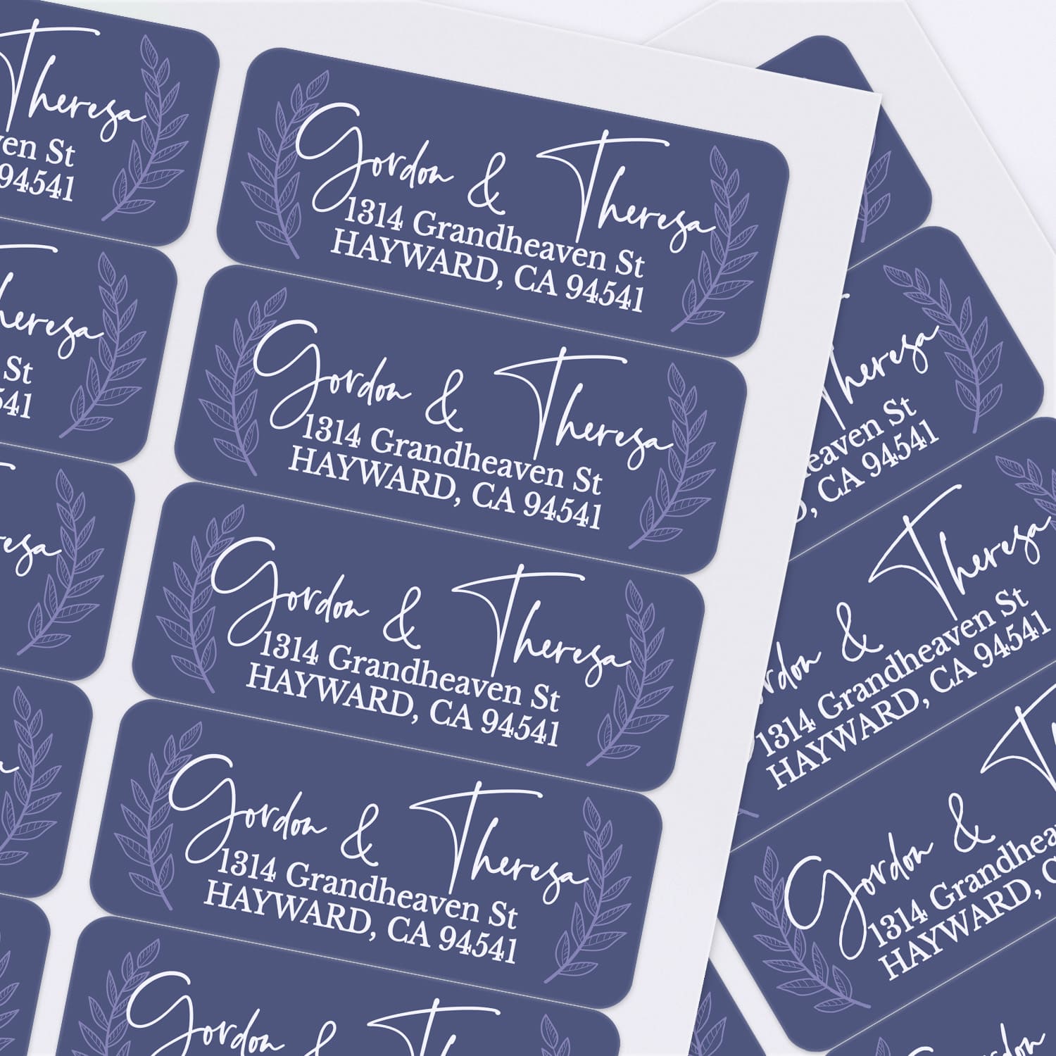 Sheet of navy personalized address labels with laurel leaf accents and stylish calligraphy font, perfect for weddings and everyday mailing - XOXOKristen