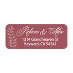 Close-up of burgundy return address sticker with graceful white calligraphy script and botanical branch motif, printed on rectangular label - XOXOKristen