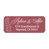 Close-up of burgundy return address sticker with graceful white calligraphy script and botanical branch motif, printed on rectangular label - XOXOKristen