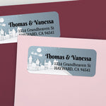 Personalized rectangular return address label with snowy winter village illustration, blue gradient background, and bold black typography - XOXOKristen